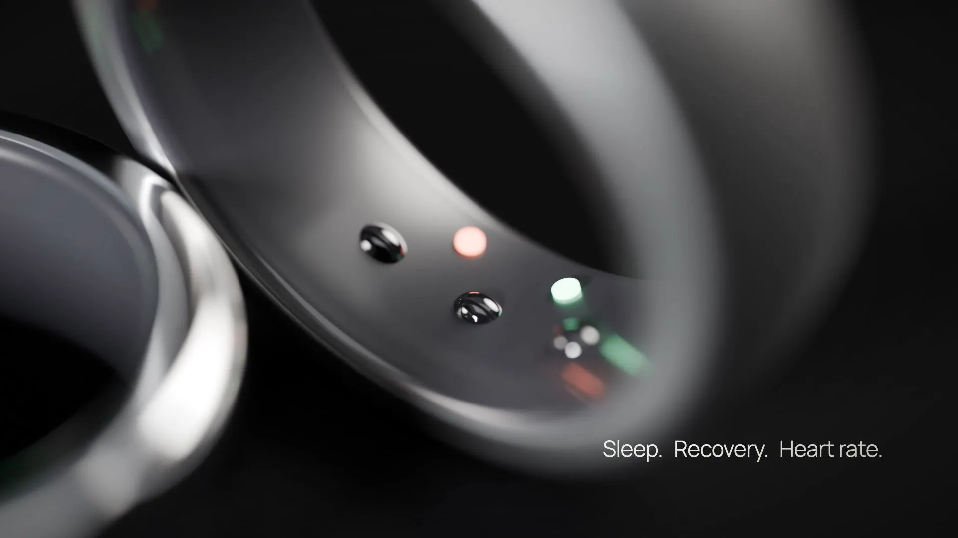 Macro inside the titanium band: three sensor domes and two LED windows set into the dark liner