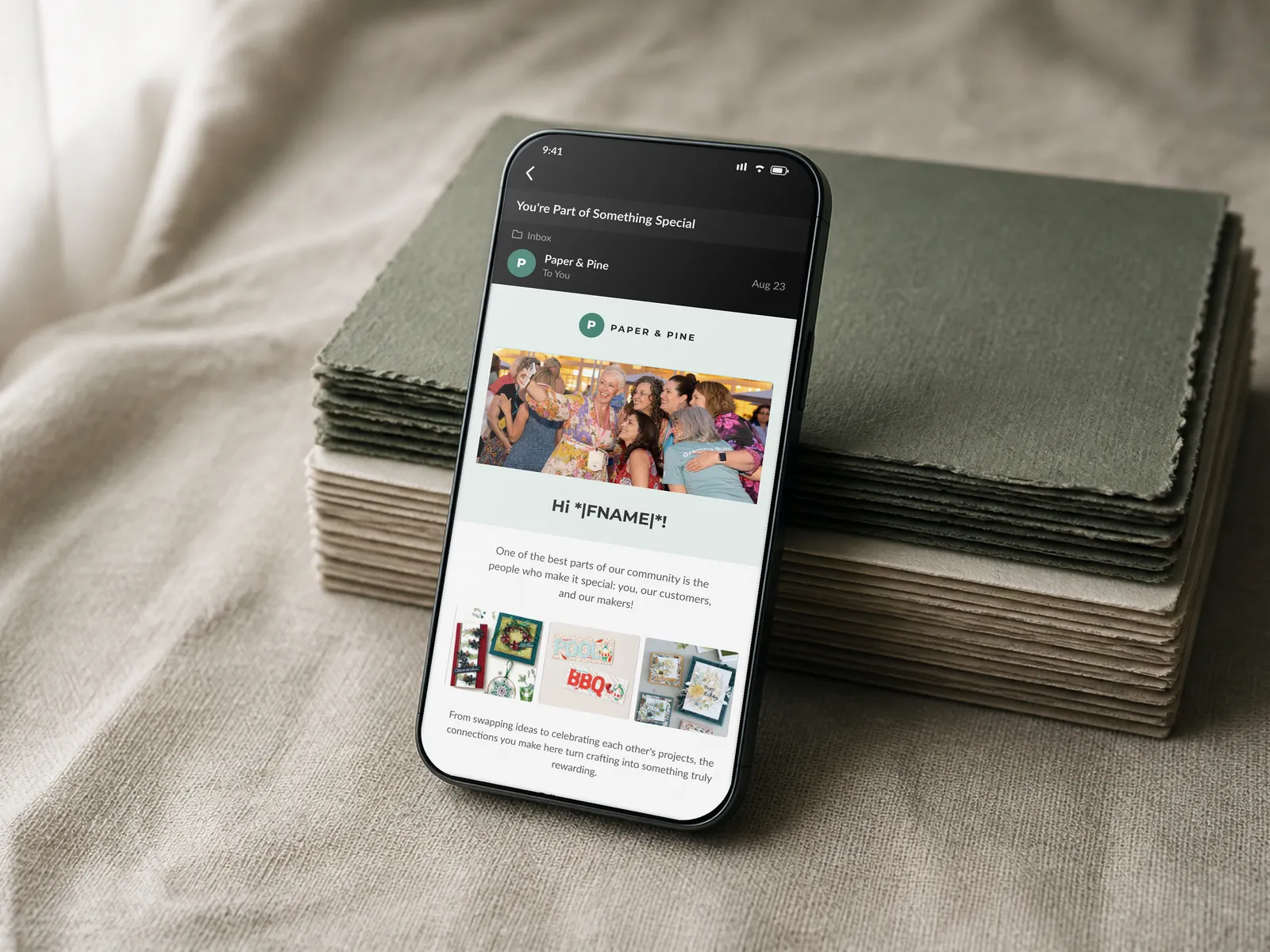 Email 4, Community, crafter stories and an invitation to join shown on a phone in the same propped scene